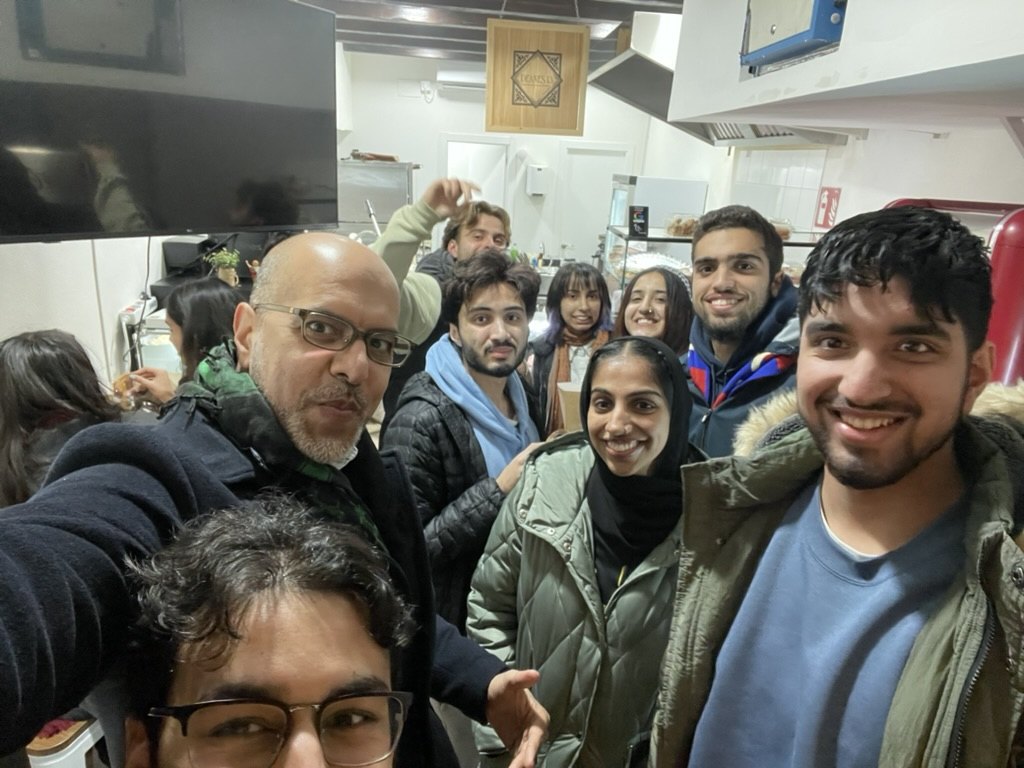 Queen City Diwan founder Haroon Moghul with participants in Spain